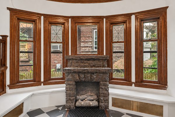 The foyer's bay of windows above the stone fireplace