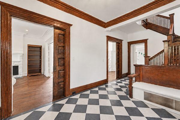 Millwork and stained woodwork framing the foyer's openings