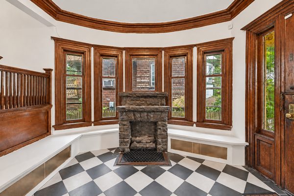 Built-in window seats under the foyer's bay windows