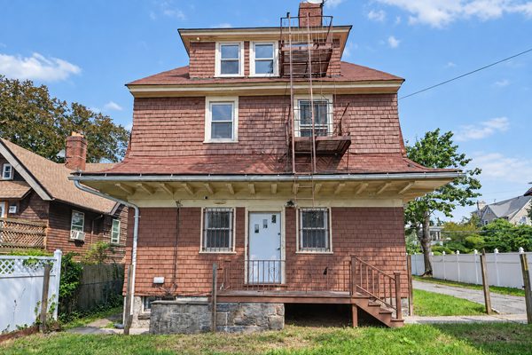 The house seen straight on from the sidewalk