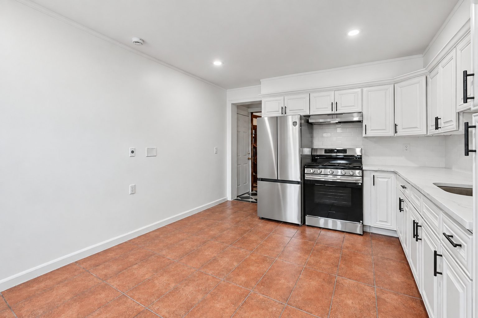 The large eat-in kitchen with new appliances, countertops and updated cabinetry