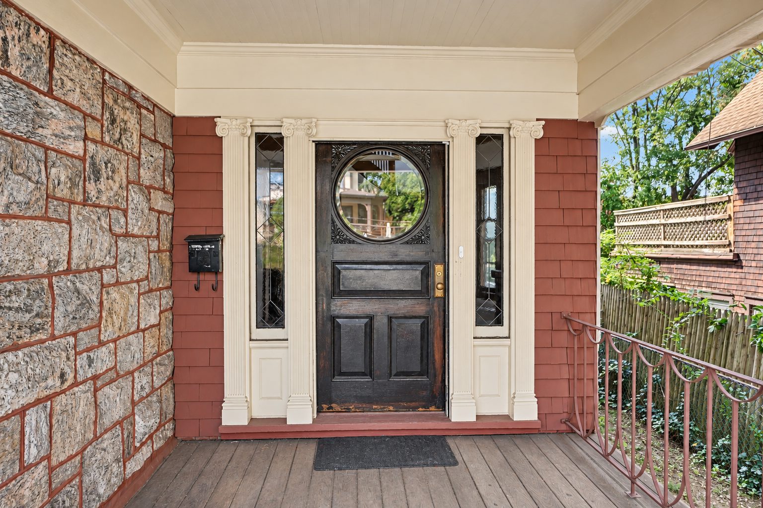 The front porch and the custom solid oak front door with its circular looking glass