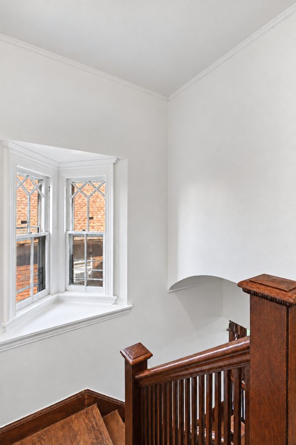 A leaded-glass window at the stair landing
