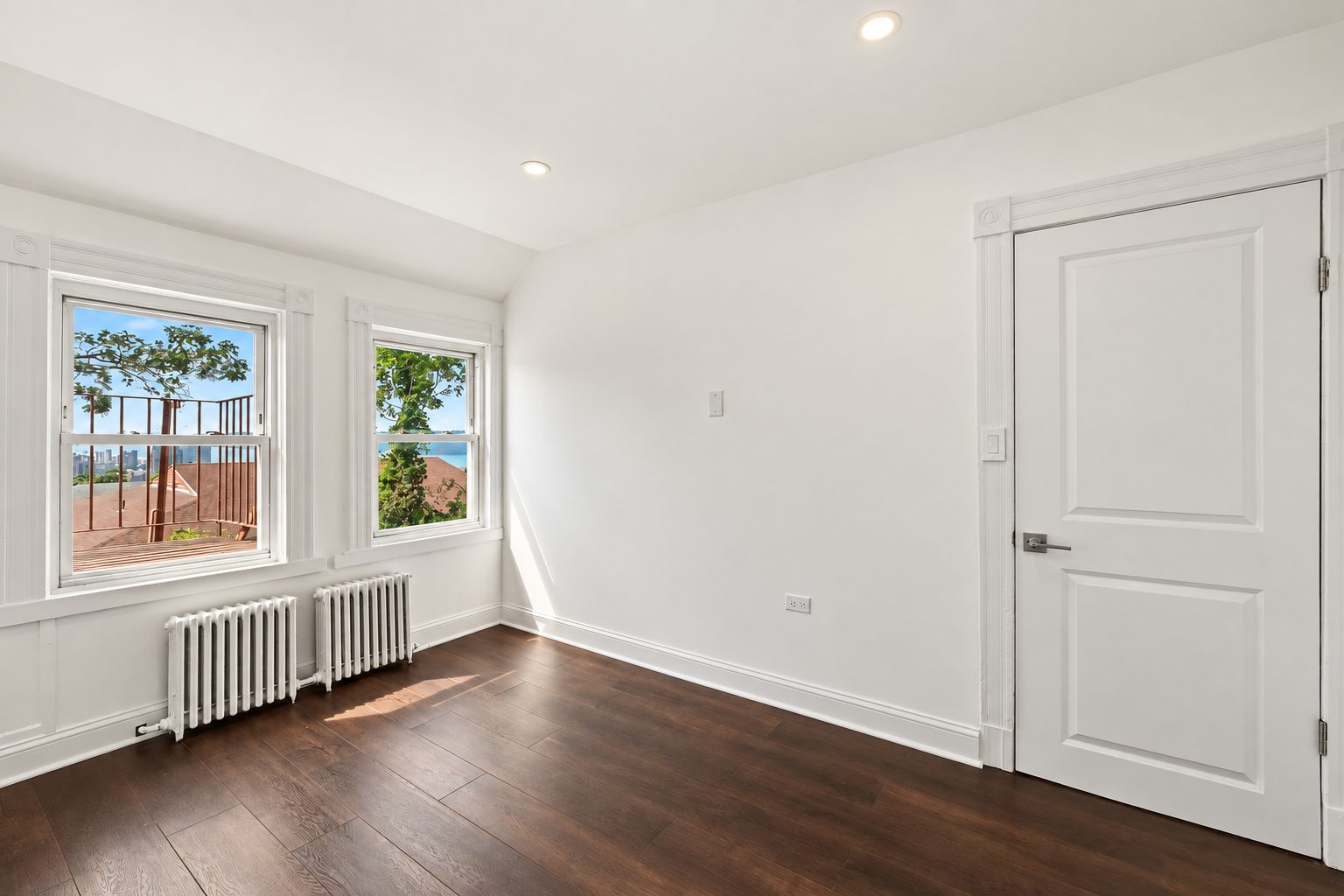 A second-unit bedroom with windows onto the river